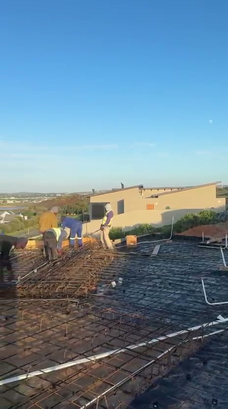 Construction crew preparing reinforcement on suspended slab